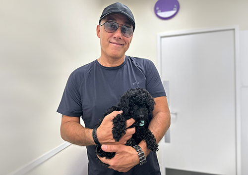 health plan page pic a man holding a puppy